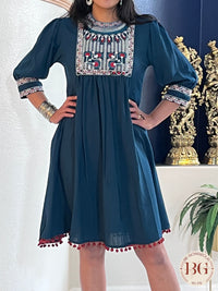 Knee Length dress in gorgeous blue color with red pompom