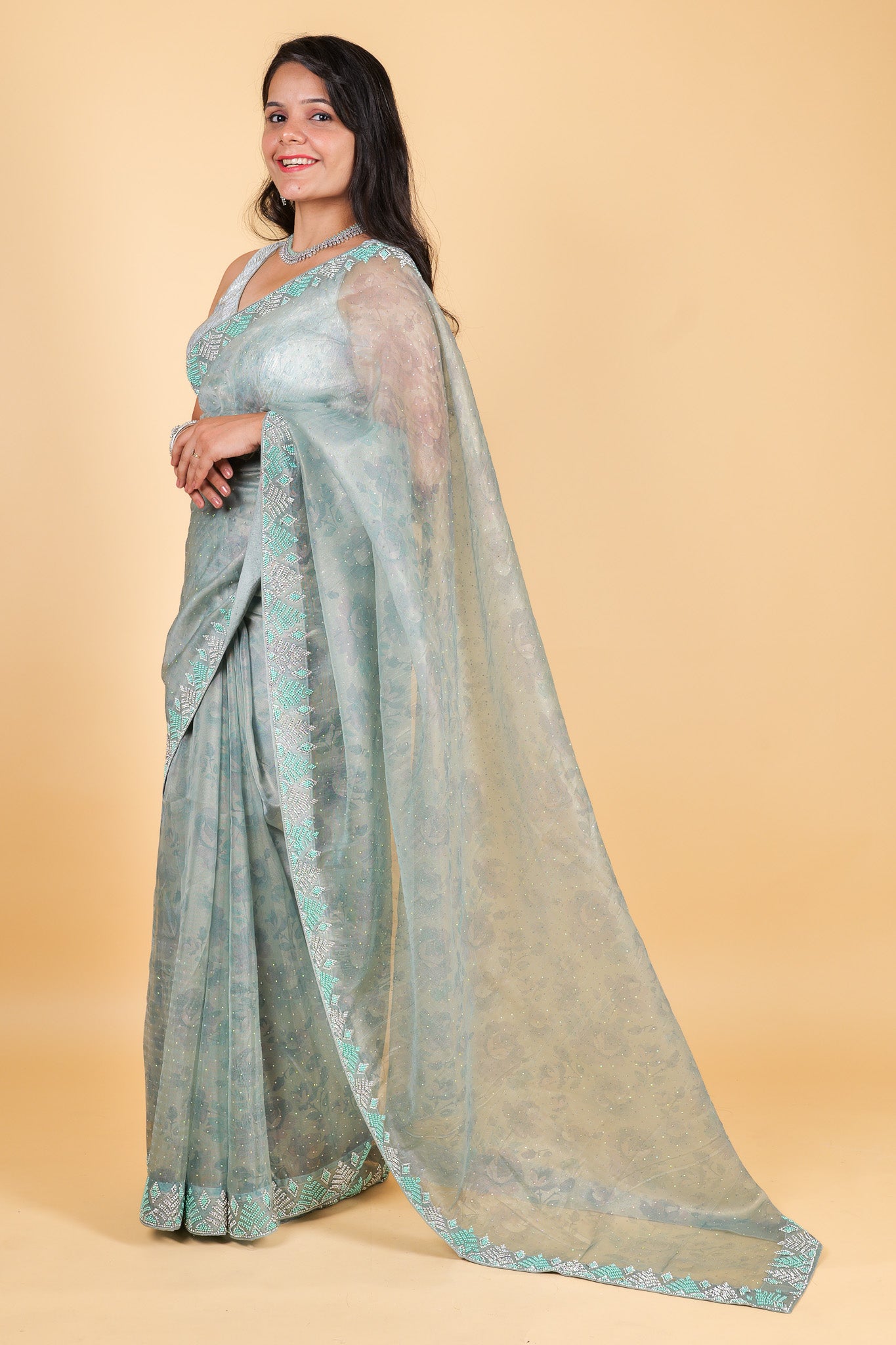 Net saree with print, swarosvki and sequin work - blue color