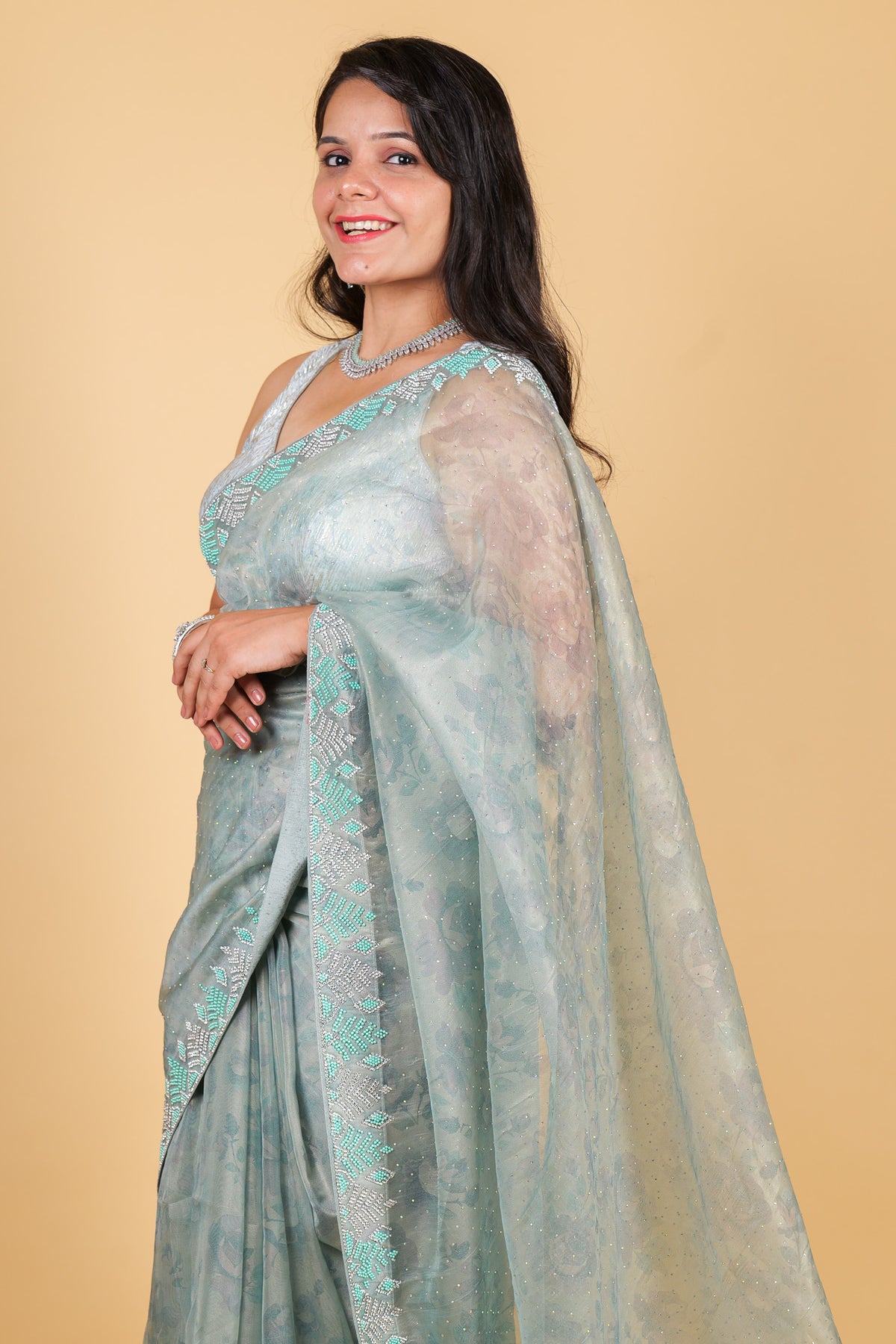 Net saree with print, swarosvki and sequin work - blue color