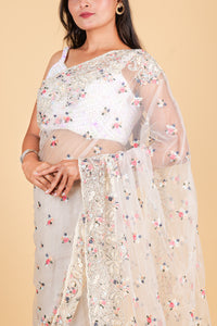 Net saree with multicolor thread embroidery, swarosvki and sequin work - off white color